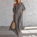 Back view of a gray and white striped off-shoulder maxi dress showing design details, casual style.