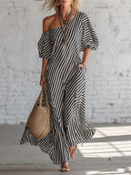 Lifestyle shot of a gray and white striped off-shoulder maxi dress with pockets, casual chic style.