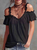 Front view of the black off-shoulder blouse featuring ruffled sleeves, elegant and stylish for a capsule wardrobe.