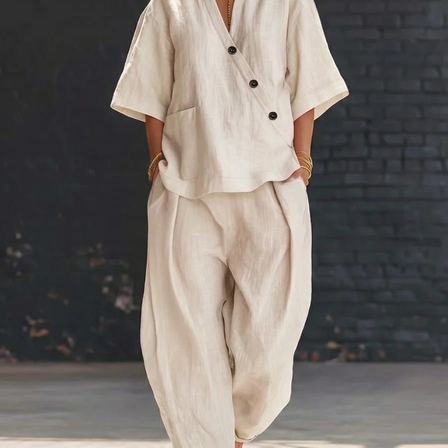 Lifestyle shot of loose fit beige two-piece set with v-neck top and high waist trousers, chic summer style.