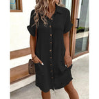 Lifestyle view of a black V-neck A-line shirt dress featuring button front and short sleeves, ideal for chic fashion.