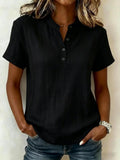 Front view of the black short sleeve blouse showcasing a v-neck and rolled sleeves, elegant minimalist design.