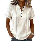 Front view of the white short sleeve blouse featuring a v-neck and rolled sleeves, chic minimalist style.