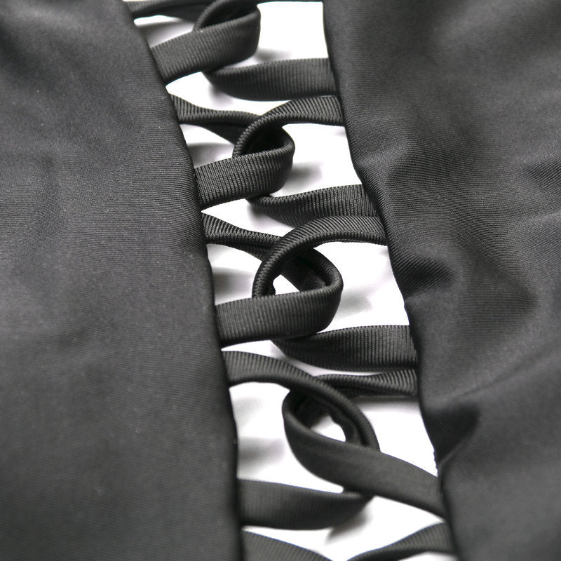 Close-up detail of black spandex bikini with ribbon detailing, showcasing its smooth texture.
