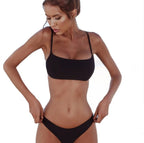 Side view of the black tube top bikini swimsuit, highlighting its sleek design and high-cut bottoms.