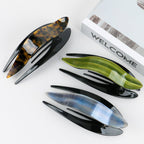 Detail close-up of an elegant acetate hairpin in tortoise shell, emphasizing its stylish design.