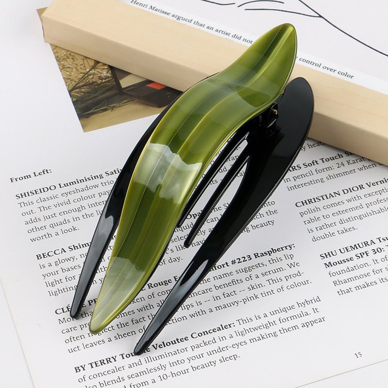 Detail close-up of green acetate hairpin, highlighting its smooth finish and stylish look.