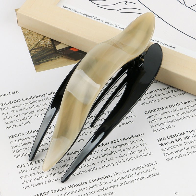 Detail close-up of leopard print acetate hairpin, highlighting its chic design and vibrant colors.