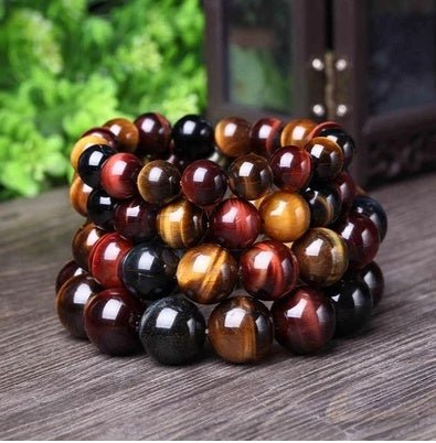 Detail close-up of the tiger eye bracelet featuring natural stones in brown and gold.