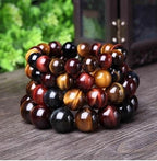Detail close-up of the tiger eye bracelet featuring natural stones in brown and gold.