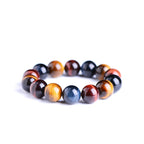 Close-up of the tiger eye bracelet showcasing round beads with color variation in brown, black, and gold.
