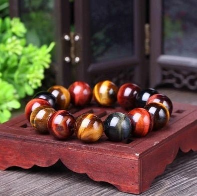 Detail close-up of the tiger eye bracelet featuring round beads in brown and gold.
