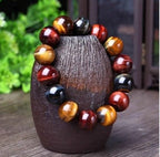 Detail close-up of the tiger eye bracelet featuring round beads in brown and gold.