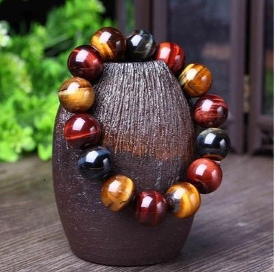 Detail close-up of the tiger eye bracelet featuring round beads in brown and gold.