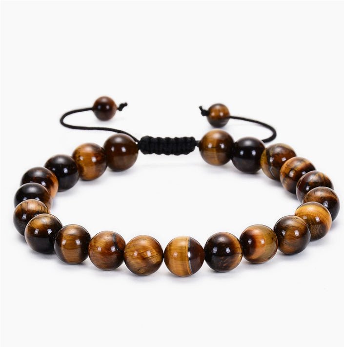 Detail of bracelet with black and gold beads and beaded design, sophisticated minimalist style.