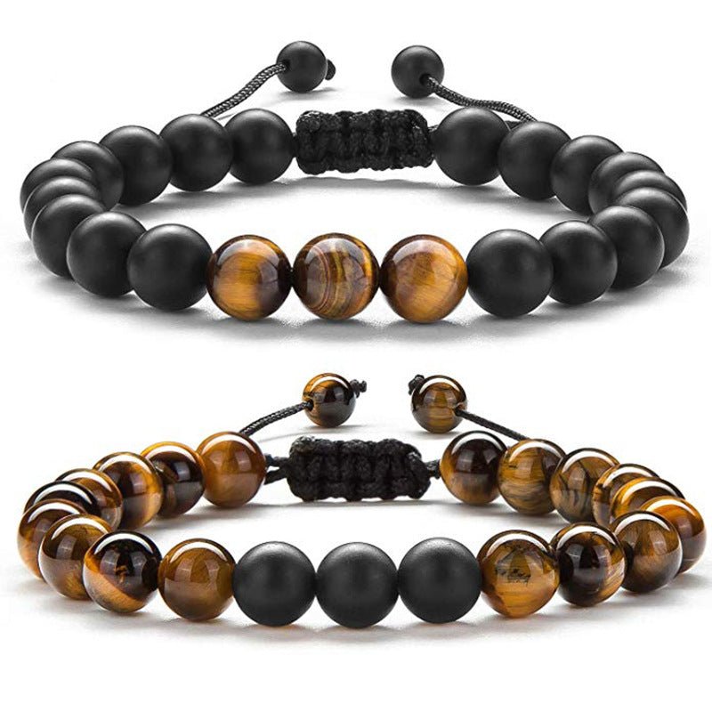 Detail close-up of black and gold couple bracelets with matte finish, featuring beaded design.