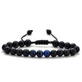 Detail close-up of black and gold couple bracelets with matte finish, showcasing elegant bead design.