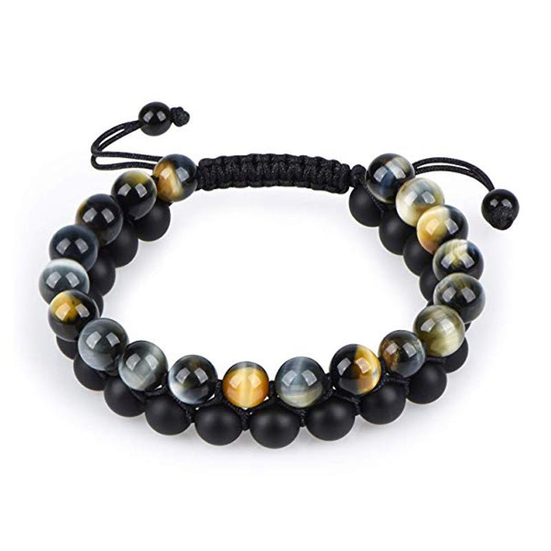 Detail close-up of black and yellow beaded bracelet with matte finish, chic couple accessory.