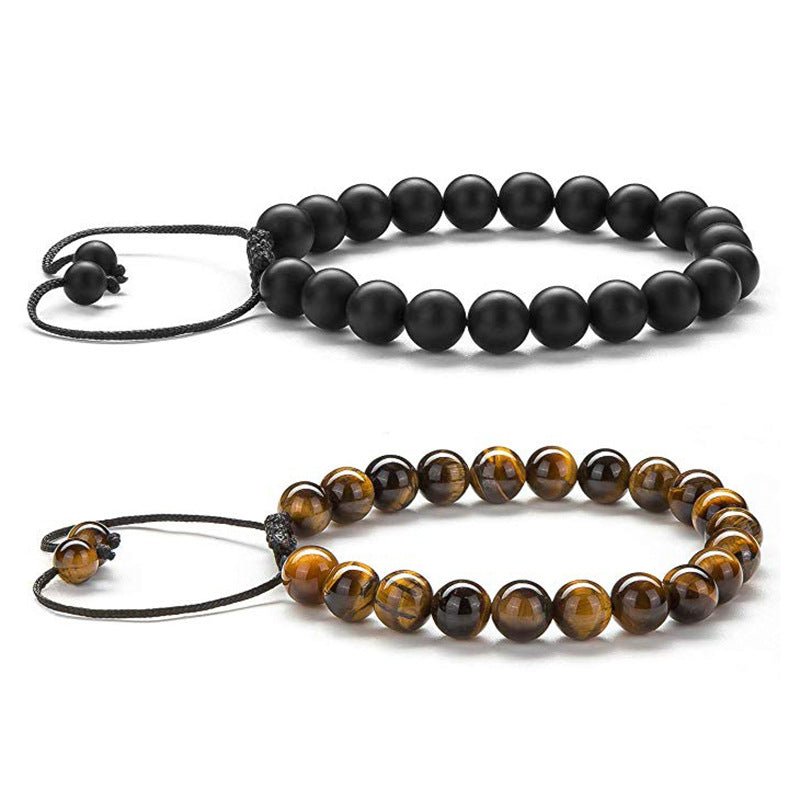 Lifestyle shot of couple bracelets with black and brown beads, matching minimalist design.