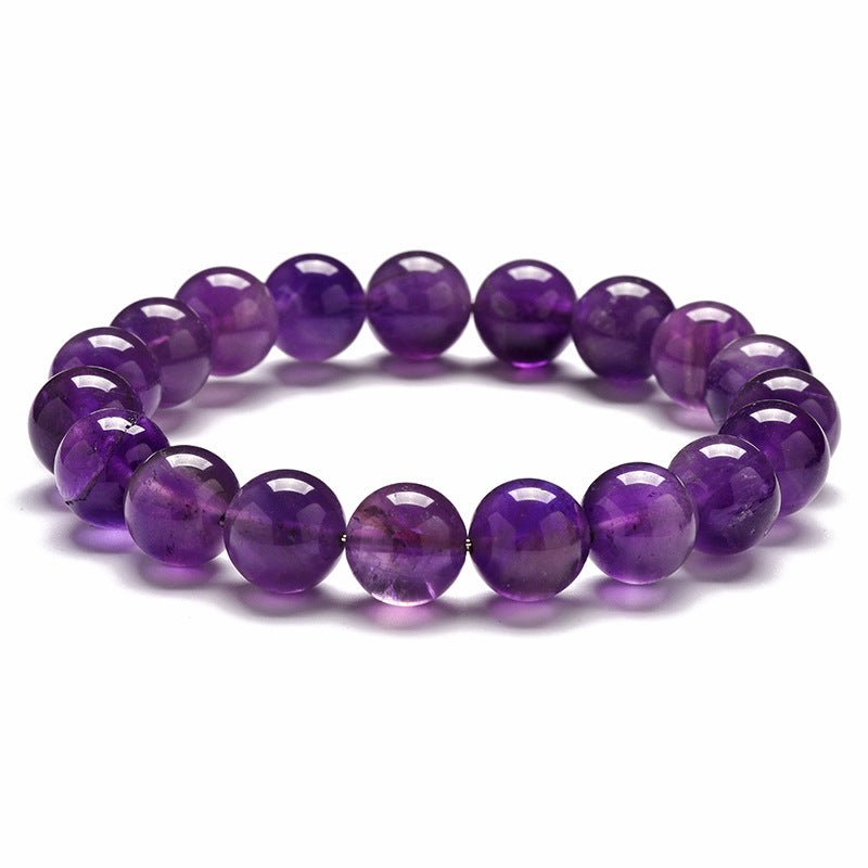 Detail close-up of an amethyst stone bracelet showcasing its natural stones.