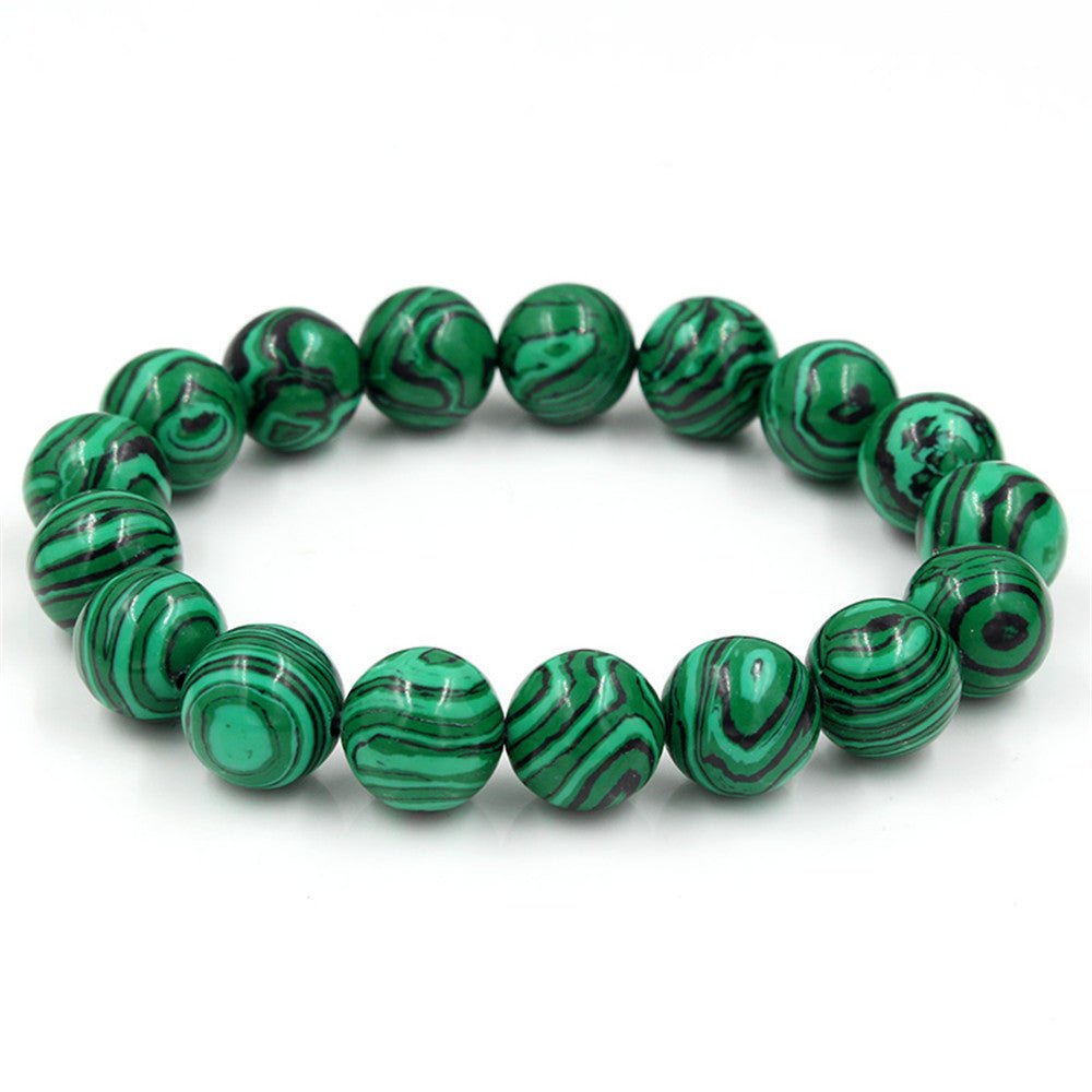 Tiger Eye Stone Bracelet with round green beads on a white background