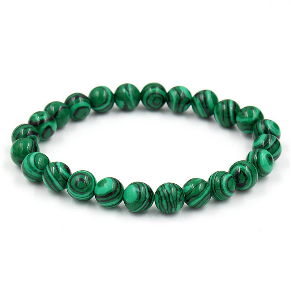 Tiger Eye Stone Bracelet with round green beads on a white background