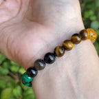 Lifestyle shot of the citrine malachite bracelet featuring multiple natural stones in a casual setting.