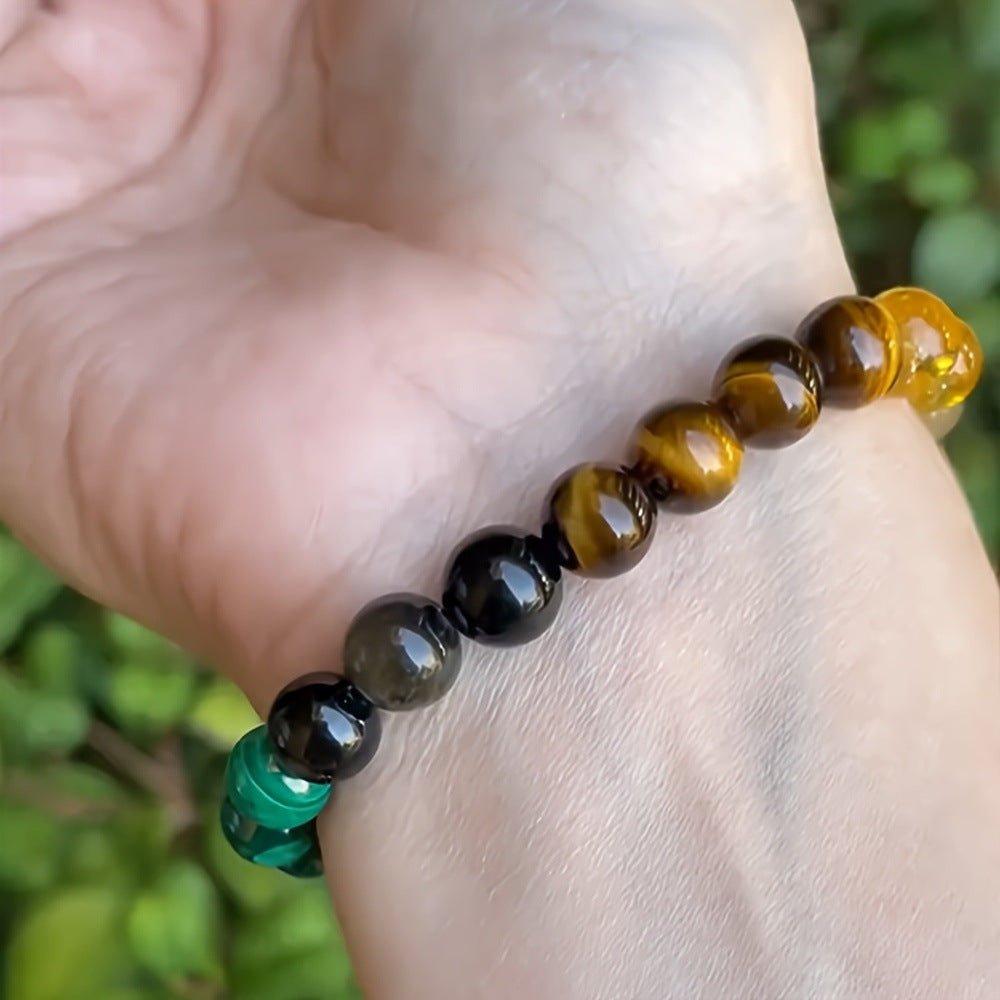 Lifestyle shot of the citrine malachite bracelet featuring multiple natural stones in a casual setting.