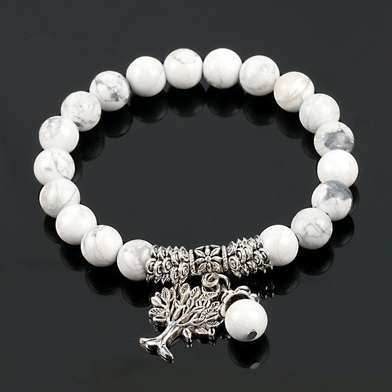Detail close-up of the vintage white turquoise bead bracelet with tree charm, showcasing frosted beads.