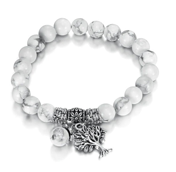 Side view of the vintage white turquoise bead bracelet highlighting its elastic band and tree charm.