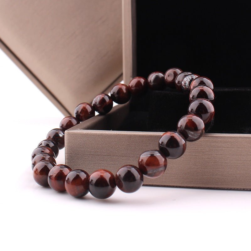 Detail close-up of vintage red tiger eye bracelet highlighting red and brown 8mm beads with smooth finish.
