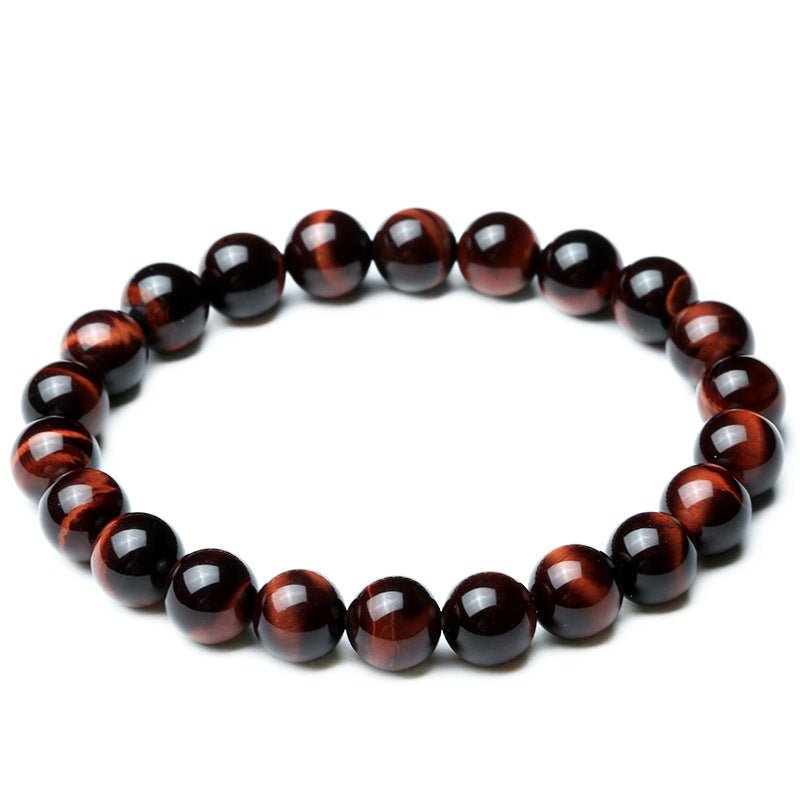 Detail close-up of vintage red tiger eye bracelet with smooth finish on a white background, showcasing bead design.