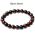 Detail close-up of vintage red tiger eye bracelet showcasing stretch design and bead details on a white background.