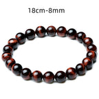 Detail close-up of vintage red tiger eye bracelet showcasing stretch design and bead details on a white background.