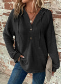 White waffle hooded pullover sweater with hood and button detail, elegant lifestyle shot.