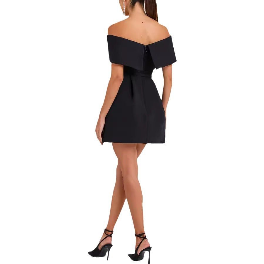 Back view of the black off-shoulder dress showcasing the waist belt, sophisticated minimalist design.