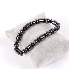 Close-up detail of black beaded Magnetic Therapy Bracelet on white background, highlighting its elegant features.