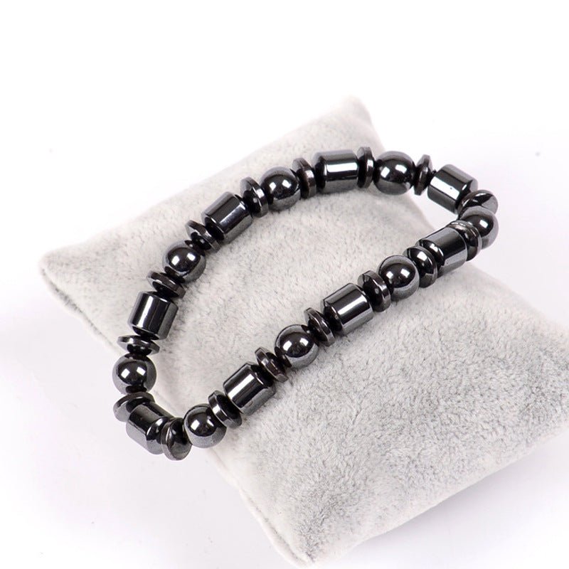 Close-up detail of black beaded Magnetic Therapy Bracelet on white background, highlighting its elegant features.