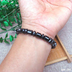 Close-up of black and silver Magnetic Therapy Bracelet, highlighting its beaded design and magnetic elements.