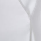 Close-up detail of the seam design on the white lapel blazer, highlighting its sophisticated craftsmanship.