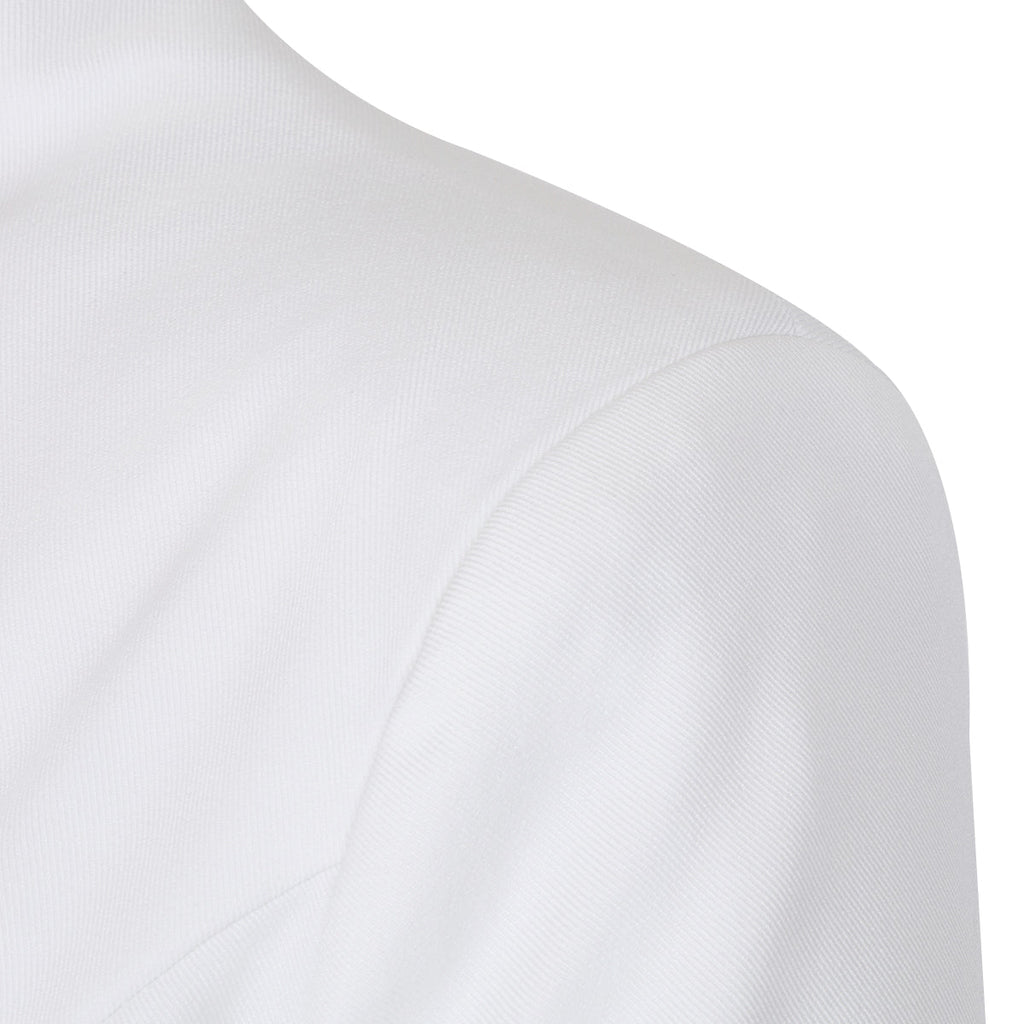Detail shot of the shoulder area of the white lapel blazer, highlighting its tailored craftsmanship.