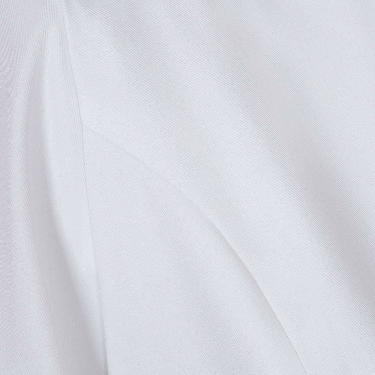 Close-up of the fabric texture of the white lapel blazer, illustrating its smooth and structured material.