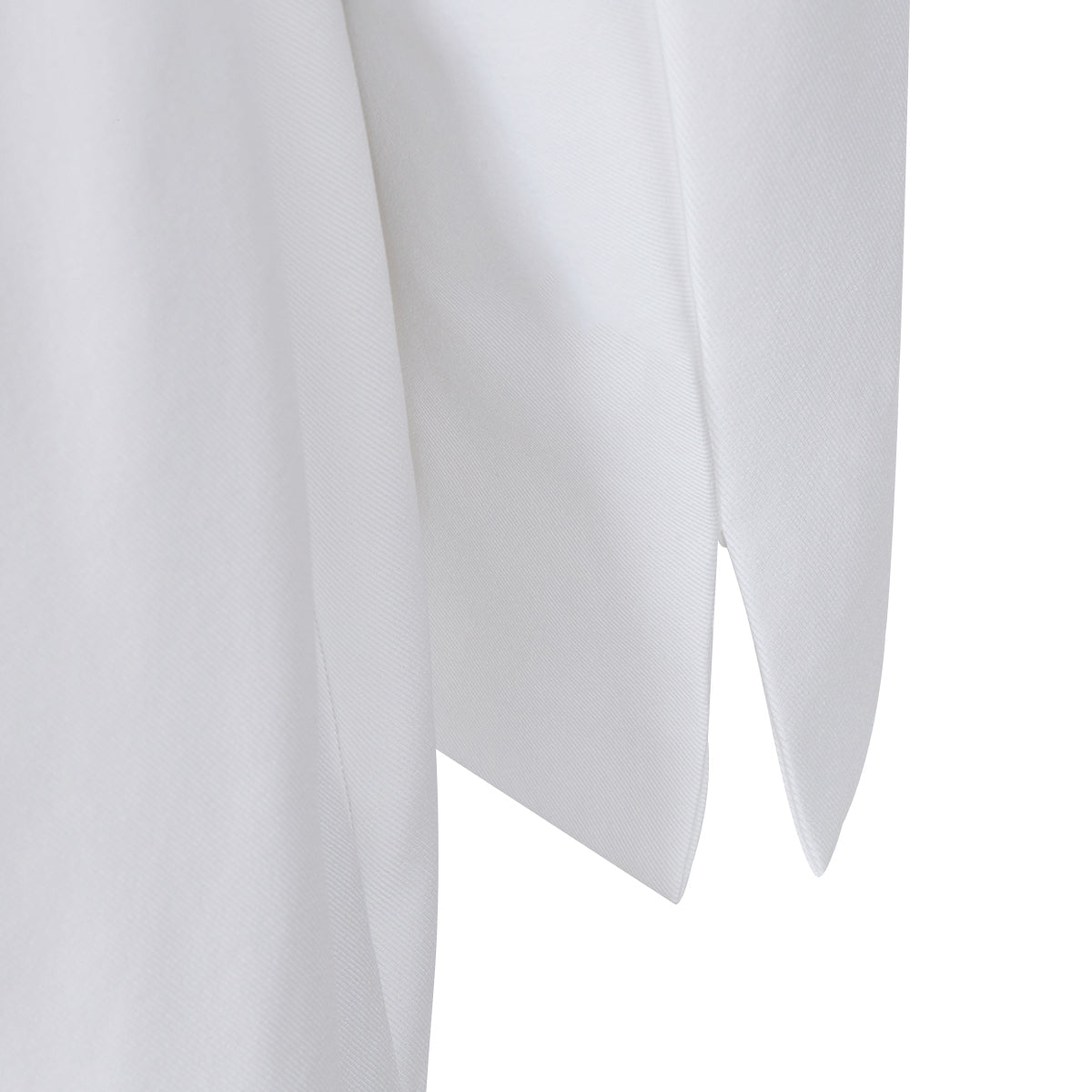 Detail shot of the hem of the white lapel blazer, showcasing its refined finish.