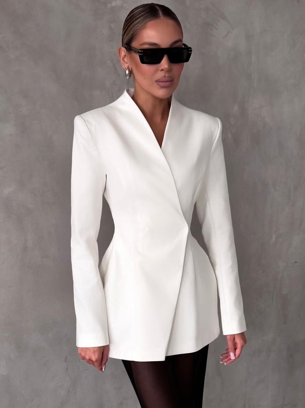 Lifestyle shot of a white lapel blazer with tailored fit, showcasing its chic design against a natural background.