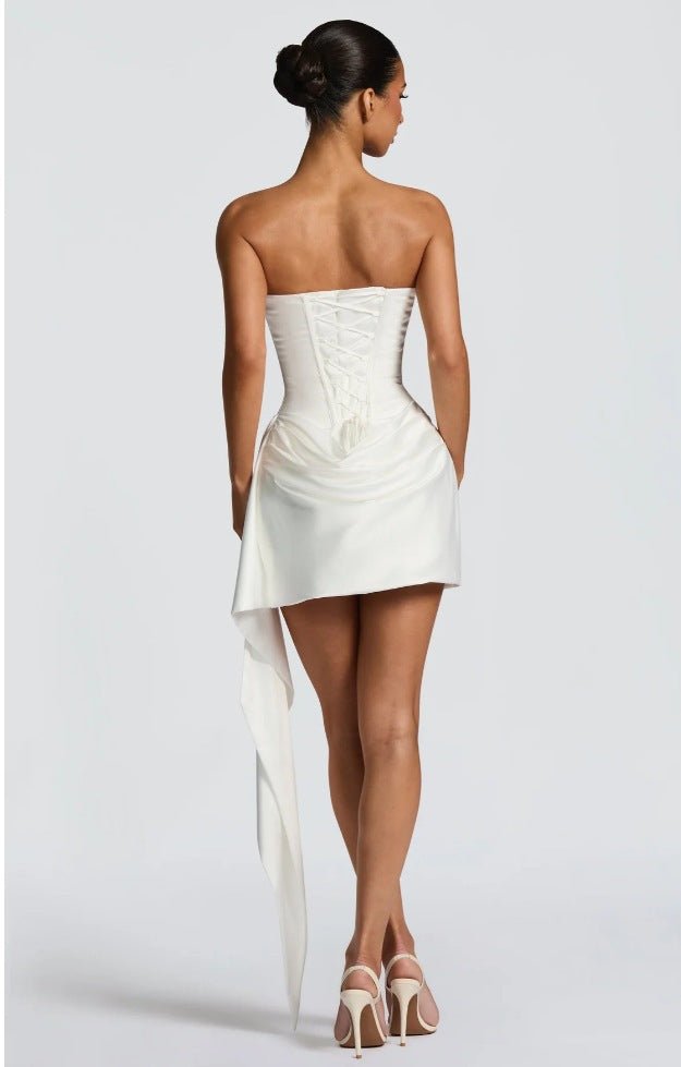 Back view of a white satin sleeveless fishtail dress, highlighting its elegant minimalist style and chic design