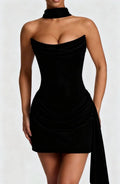 Lifestyle shot of a black satin sleeveless fishtail dress, sophisticated minimalist style with a flowing hem