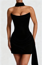 Lifestyle shot of a black satin sleeveless fishtail dress, sophisticated minimalist style with a flowing hem