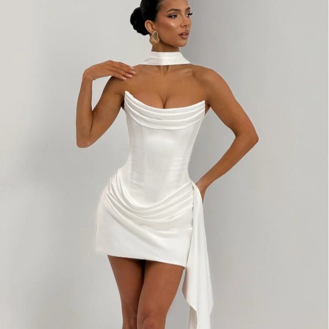 Lifestyle view of a white satin sleeveless fishtail dress, showcasing its elegant design and chic silhouette