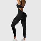 Side view of the black sleeveless yoga jumpsuit featuring a stylish cut-out design.