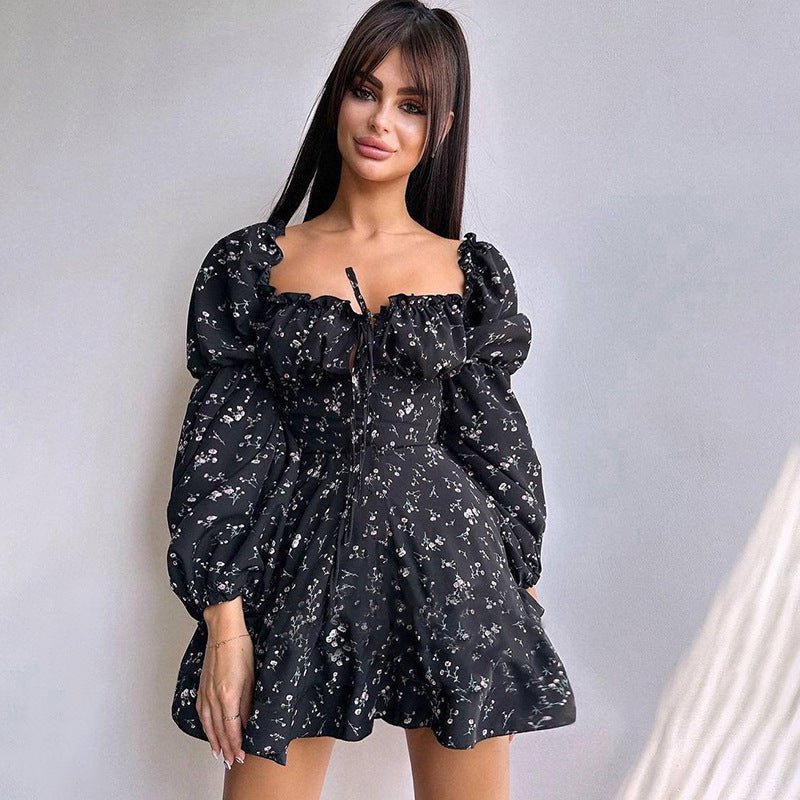 Long black floral dress with puff sleeves in a lifestyle shot, showcasing chic elegance.